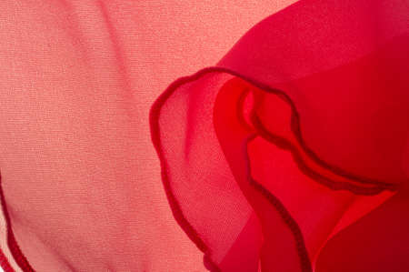 Red silk folded fabric background, banner or cover design. luxurious textile decoration backdrop for poster, Scarlet drapery material with soft satin waves, poster Texture. Background. Pattern.の写真素材