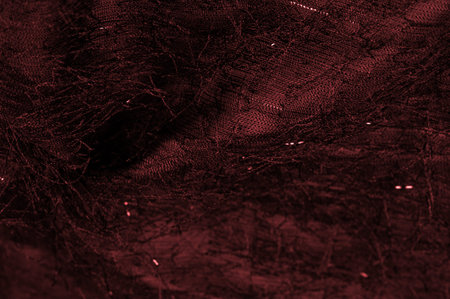 Red silk fabric in burgundy color with sequins and yarns on the surface of the fabric. This ombre...