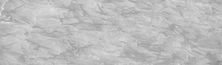 River ice: The presence of ice on rivers changes their behavior, hinders their use and causes serious economic problems. Full frame of textures formed by a block of cracked freezing waterの写真素材