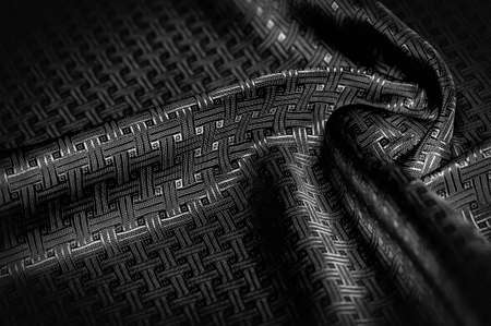Black silk fabric with a fine checkered pattern. Background texture, pattern.の写真素材
