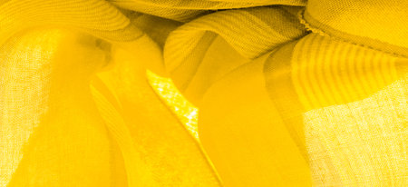 Silk fabric of yellow color, Texture. Background. of the color between green and orange in the...