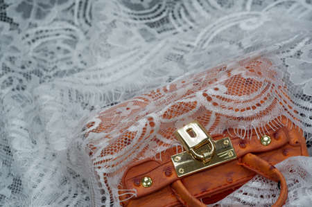 White lace on a black background. Template for wedding invitation and greeting card with lace fabric background. Souvenir women's handbagの写真素材