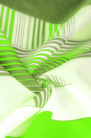 Silk fabric, geometric intersecting lines, green and white pattern of straight lines in different...