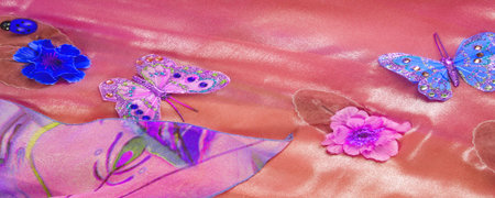 Texture, background, pattern. Silk fabric with butterflies. blue and pink flowers on a red backgroundの写真素材