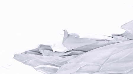 crumpled white fabric on white background, closeup of photoの写真素材