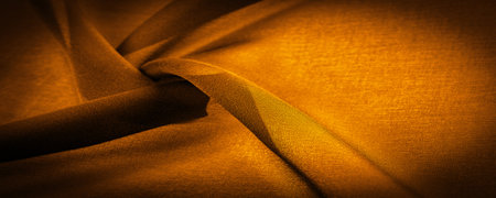 Dark sepia brown-yellow chiffon silk is a soft transparent fabric with a slight roughness (matte, crepe) due to the use of twisted yarn. background textureの写真素材