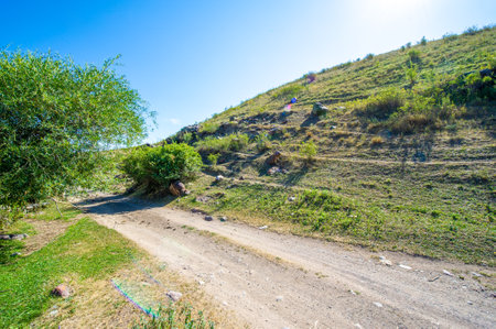 Experience the thrill of driving on a mountain dirt road. Enjoy scenic views and rugged terrain. Ideal for both adrenaline junkies and nature lovers.の写真素材