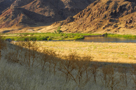 Enjoy the tranquil beauty of the river surrounded by rocks. An ideal place for fishing, kayaking or just relaxing by the water. Nature at its best with the soothing sounds of flowing water and naturalの写真素材