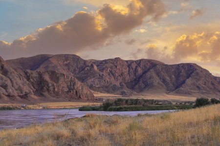 Enjoy the untouched beauty of the steppe. Discover winding rivers and impressive cliffs. Witness the stunning hues of a desert sunset.の写真素材