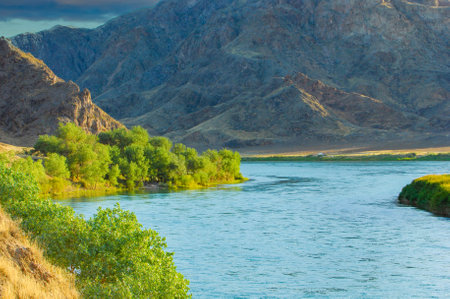 Explore the stunning natural beauty of Central Asia at sunset. Enjoy the unique landscapes of rocks, rivers and steps. Connect with nature and find peace in this serene setting.の写真素材