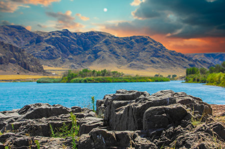 the breathtaking beauty of the steppe. Relax and unwind in a tranquil environment surrounded by nature. Watch the stunning sunset over the cliffs and river. Find peace and tranquility in this picturesque location.の写真素材