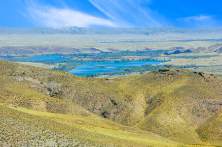 Enjoy the beauty and tranquility of the river. Dip your toes into the refreshing blue waters. Relax on the smooth rocks that line the shore. Immerse yourself in the serenity of nature's masterpiece.の写真素材