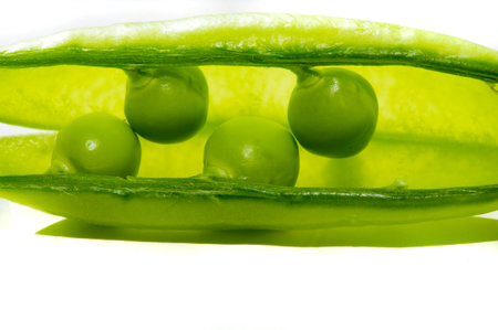 Aesthetic and visually appealing image with green peas on a white background Ideal for use in food design or advertising High quality and detailed photograph of fresh bright peasの写真素材