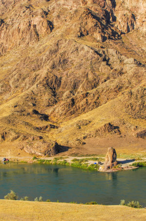 Beautiful natural scenery with a river flowing through the rocks. A popular destination for outdoor activities such as fishing and camping. Breathtaking views of the river framed by rock formations.の写真素材