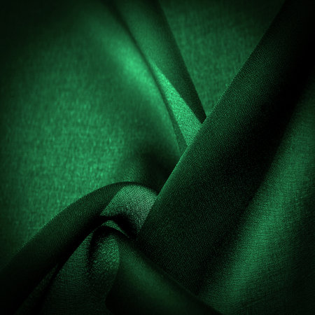 Sheer dark green chiffon silk, Emerald abstract background. Green fabric closeup. - it is a soft transparent fabric with a slight roughness (matte, crepe) due to the use of twisted yarn. textureの写真素材