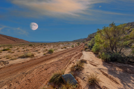 Enjoy the stunning beauty of a sunset over the mountains. Be amazed as nature shows off its grand finale. Witness the warm glow as it envelops the mountains in breathtaking colors.の写真素材