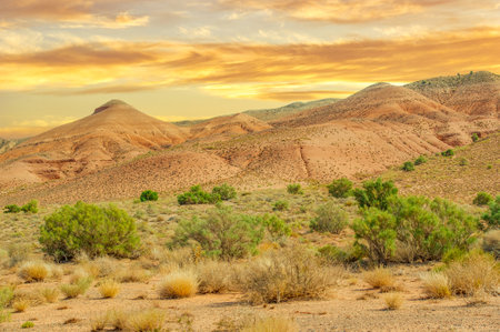 Witness the breathtaking beauty of the Red Mountains at sunset. Experience nature's masterpiece as the sun paints the mountain sky in vibrant hues. Capture unforgettable momentsの写真素材