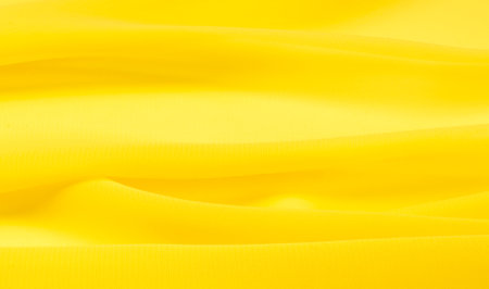 background seamless texture - yellow silk. Silk organza in pale yellow is an exceptional fabric, beautiful both on its own and as an accessory in terms of highlighting.の写真素材