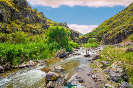 Enjoy the serene flow of the river through the majestic mountains. Enjoy the stunning beauty of the rocky canyon as nature takes your breath away. Immerse yourself in a calm environmentの写真素材