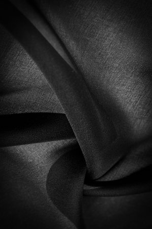 Dark black chiffon silk is a soft transparent fabric with a slight roughness (matte, creped) due to the use of twisted yarn.の写真素材