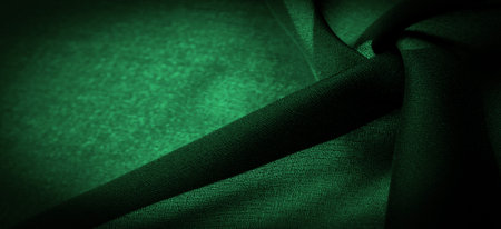 Sheer dark green chiffon silk, Emerald abstract background. Green fabric closeup. - it is a soft transparent fabric with a slight roughness (matte, crepe) due to the use of twisted yarn. textureの写真素材