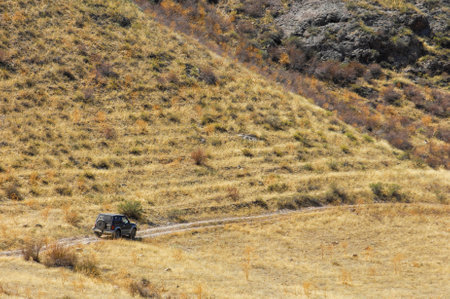 Experience the thrill of driving on rough terrain. Travel through beautiful landscapes in your reliable vehicle. Test your skills while navigating challenging mountain roads.の写真素材