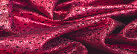 Fabric with a metallic sheen in small polka dots. Red burgundy.の写真素材