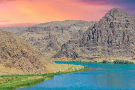 Enjoy the natural taste of clean river water. Quench your thirst with a refreshing sip of the steppe river. Feel the fresh and clean taste of water flowing through stones in the summer heat.の写真素材