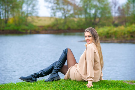 Autumn poses elegantly for a photo shoot. A picturesque lake serves as a stunning backdrop....