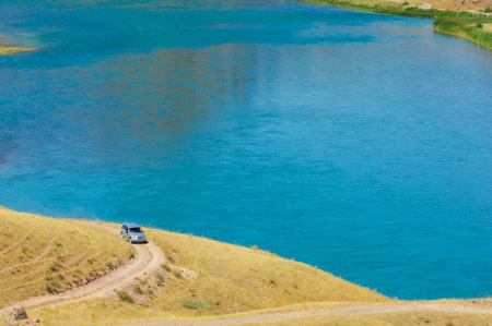 Enjoy the natural taste of clean river water. Quench your thirst with a refreshing sip of the steppe river. Feel the fresh and clean taste of water flowing through stones in the summer heat.の写真素材