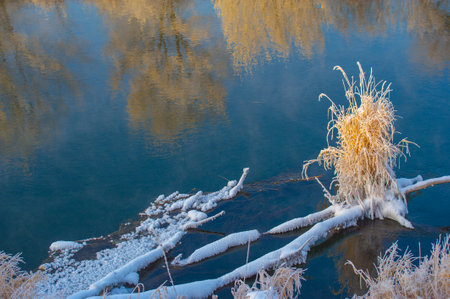 Enjoy the breathtaking beauty of the frozen river at sunrise. Witness nature's stunning winter spectacle. Capture mesmerizing photos of shimmering frost and magical landscapes.の写真素材