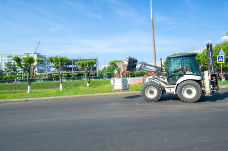 The tractor can carry various types of cargo. Can be used for paving slabs and picking up pallets with a mounted bucket.の写真素材