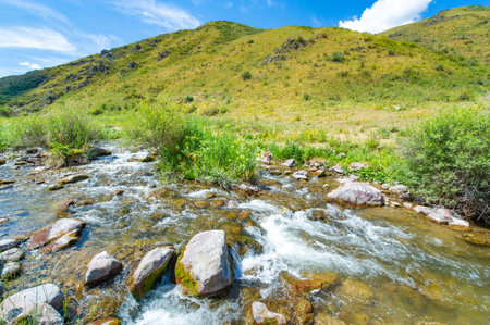 Enjoy the serene beauty of nature in the heart of the mountains. Watch the river flow gracefully through the rocky canyon. Enjoy breathtaking views and feel a sense of peace and tranquility.の写真素材