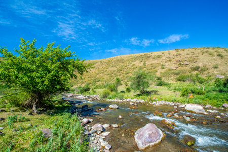 Feel the serenity of nature's beauty as you watch the flowing river. Admire the majestic rocky canyon surrounding the peaceful waters. Feel the awesome-inspiring powerの写真素材