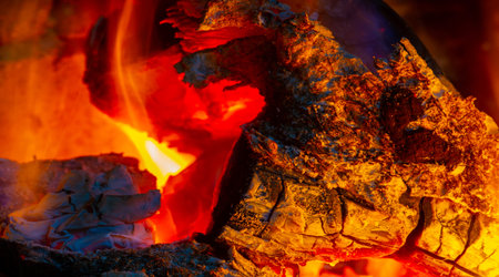 Fire in the fireplace. The illuminated area around the fire creates its own small zone In the...