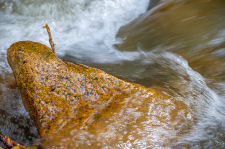water in a mountain stream. breaks through the stones. Enjoy the serene beauty of a mountain stream....