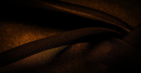 Dark sepia brown-yellow chiffon silk is a soft transparent fabric with a slight roughness (matte, crepe) due to the use of twisted yarn. background textureの写真素材