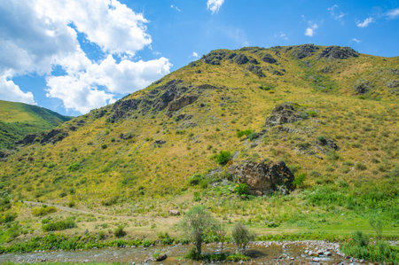 Experience the serenity of nature's beauty. See how the river flows through the rocky canyon. Immerse yourself in majestic mountain views.の写真素材