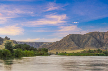 Feel the breathtaking beauty of the steppe. Discover stunning cliffs and winding rivers. Witness spectacular sunsets in shades of orange, pink and purple. Immerse yourself in the wild.の写真素材