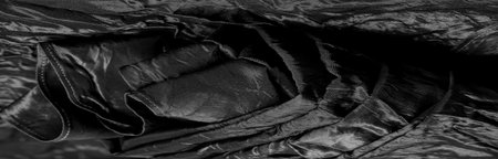 Black Silk Fabric Designed specifically for the mood, using premium black silk taffeta of the highest quality. Light, crisp and shimmery, this material creates a soft sheen.の写真素材