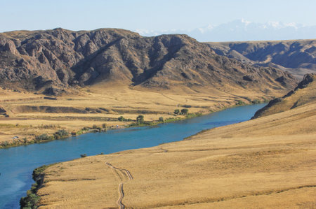 Enjoy the tranquil beauty of the river surrounded by rocks. An ideal place for fishing, kayaking or just relaxing by the water. Nature at its best with the soothing sounds of flowing water and naturalの写真素材