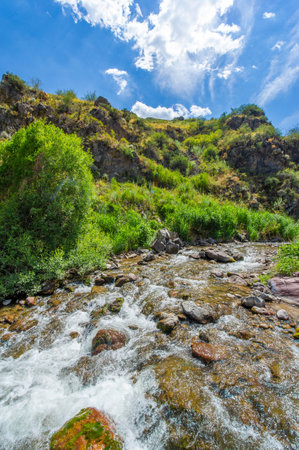 Enjoy the serene beauty of nature. Watch the river flow through the rocky canyon. Immerse yourself in the tranquility of the mountains.の写真素材