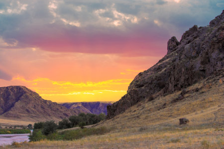 Feel the breathtaking beauty of the steppe. Discover stunning cliffs and winding rivers. Witness spectacular sunsets in shades of orange, pink and purple. Immerse yourself in the wild.の写真素材