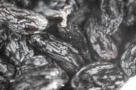 A close-up shot of juicy black raisins, perfectly sun-dried and ready to top your dishes!の写真素材
