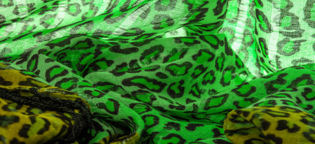 silk fabric green yellow with leopard print. Lightweight leopard print silk is perfect for your design, looks stylish! Texture, background, patternの写真素材