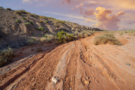 Enjoy the stunning beauty of the sunset over the red clay mountains. Capture the breathtaking colors and scenery of nature's masterpiece. Witness the wonders of nature,の写真素材