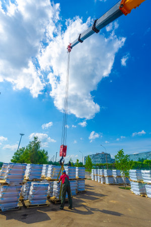10 08 2014 Russia Chelny Builders lay concrete for the sidewalk. Use of tools such as concrete mixers and power trowels. Measuring and leveling the surface to ensure proper installation.の写真素材