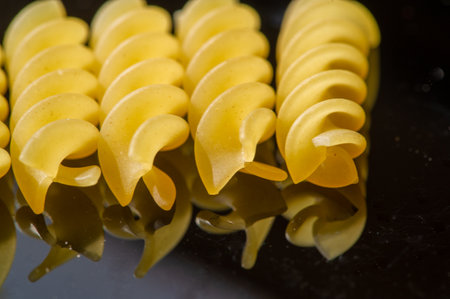 Delicious fusilli pasta made from high quality Italian wheat. Golden color and perfect texture for a hearty lunch. Enjoy the taste of Italy with every bite.の写真素材