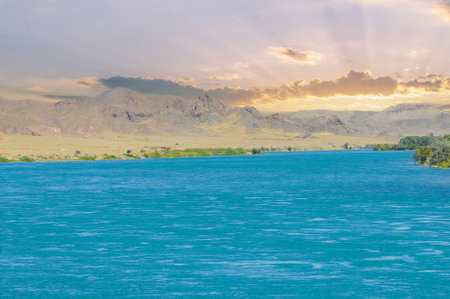 silence and tranquility in the embrace of nature. Watch the stunning colors of the sky as the sun sets over the river. Listen to the soothing sounds of flowing water and rustling leaves.の写真素材