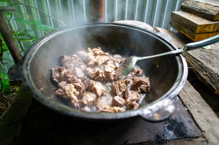 Enjoy the smoky flavor of our kettle roast lamb. Enjoy the taste of meat cooked over an open fire. Experience the unforgettable experience of grilling our smoked meats.の写真素材